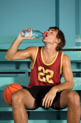 Basketball player drinking from water bottle