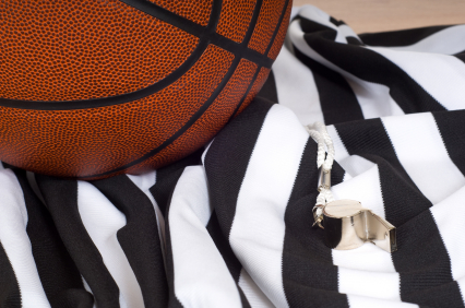 Close up of basketball, referee jersey and whistle