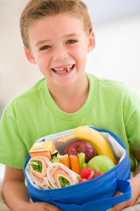 Gap toothed boy with bowl of healthy food