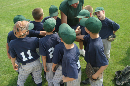Baseball coach with team in pregame huddle