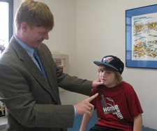 Dr. William P. Meehan, III examining young patient