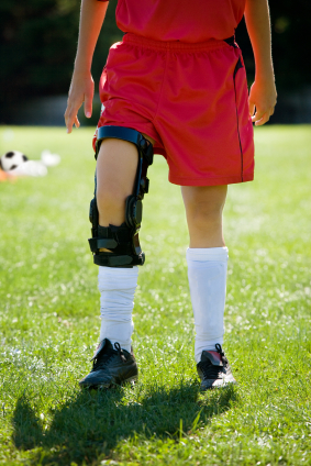 Female soccer player with knee brace for ACL injury