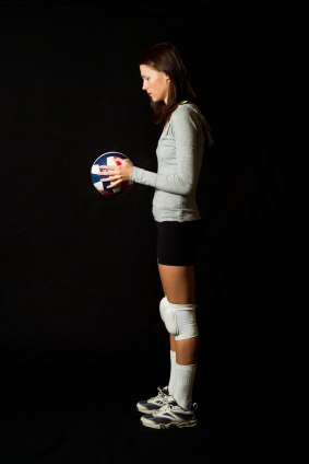 Female volleyball player about to serve