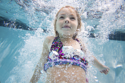 Girl under water in pool