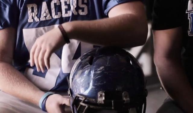 Matt Meyer displaying heavily scuffed football helmet