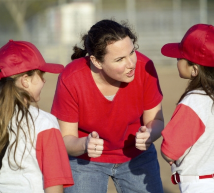 Woman coach talking to T-ball players