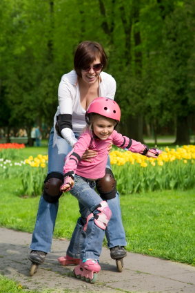 Mom teaching child to roller blade