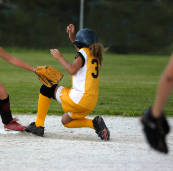 Softball player being tagged out
