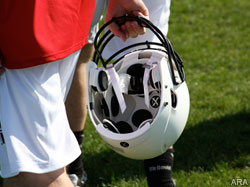 Player holding football helmet