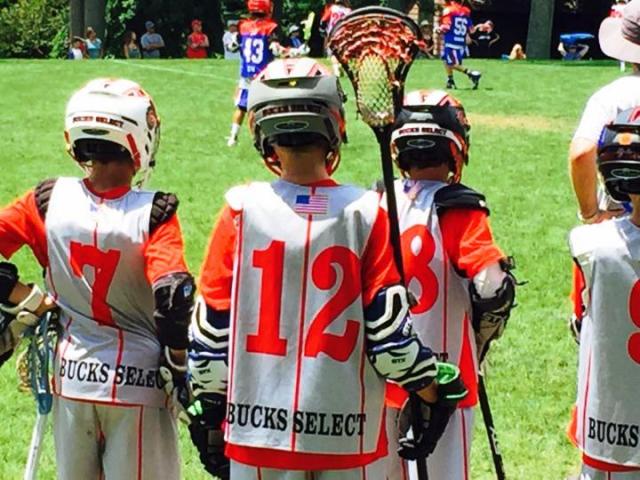 Young lacrosse players on the sidelines