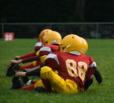 Young football players stretching