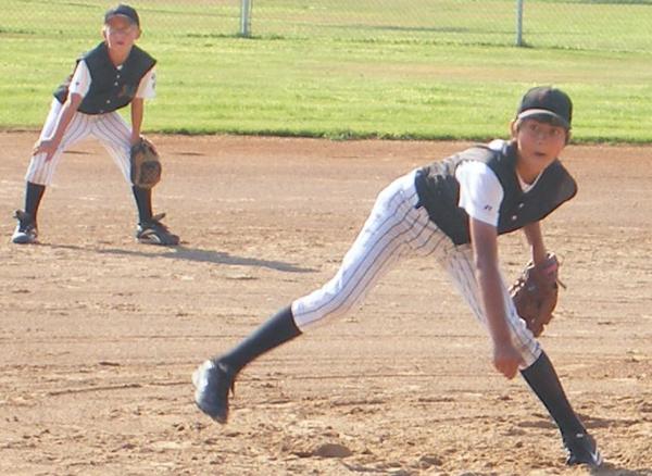 Little League pitcher delivers to plate