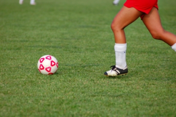 Female soccer player dribbling ball